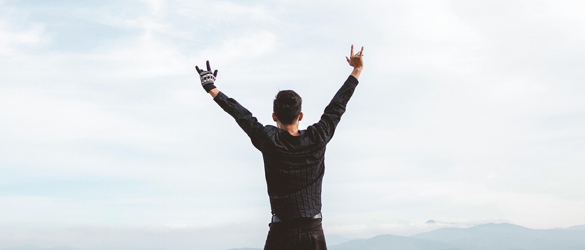 Man with hands up in nature