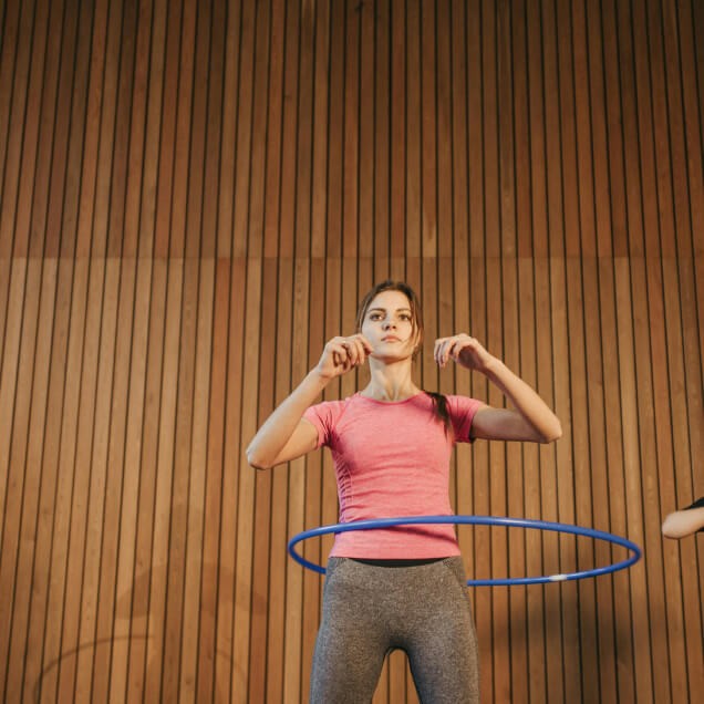 Woman exercising with a hula hoop
